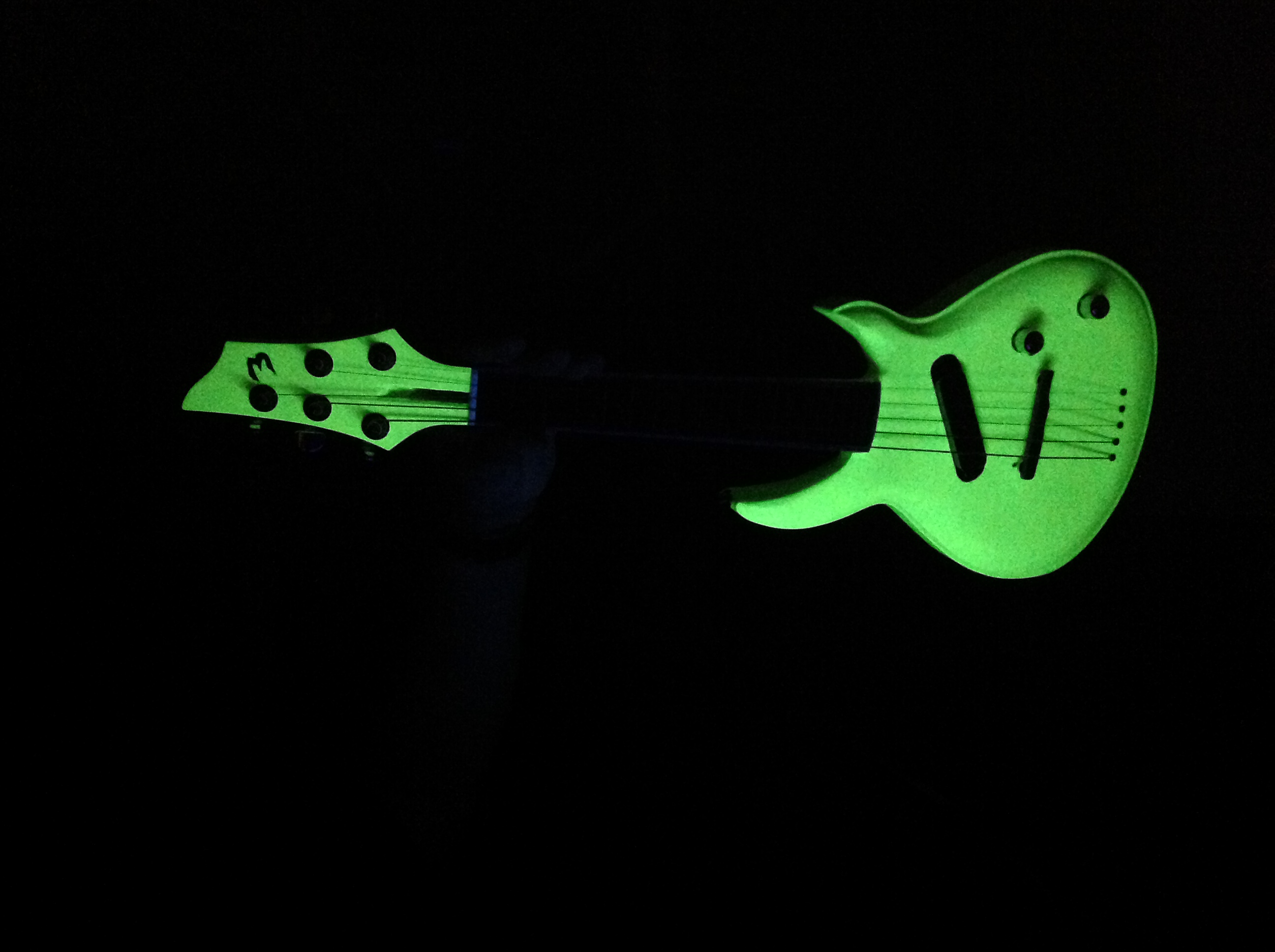 Profile view of a glow in the dark mandolin - guitar